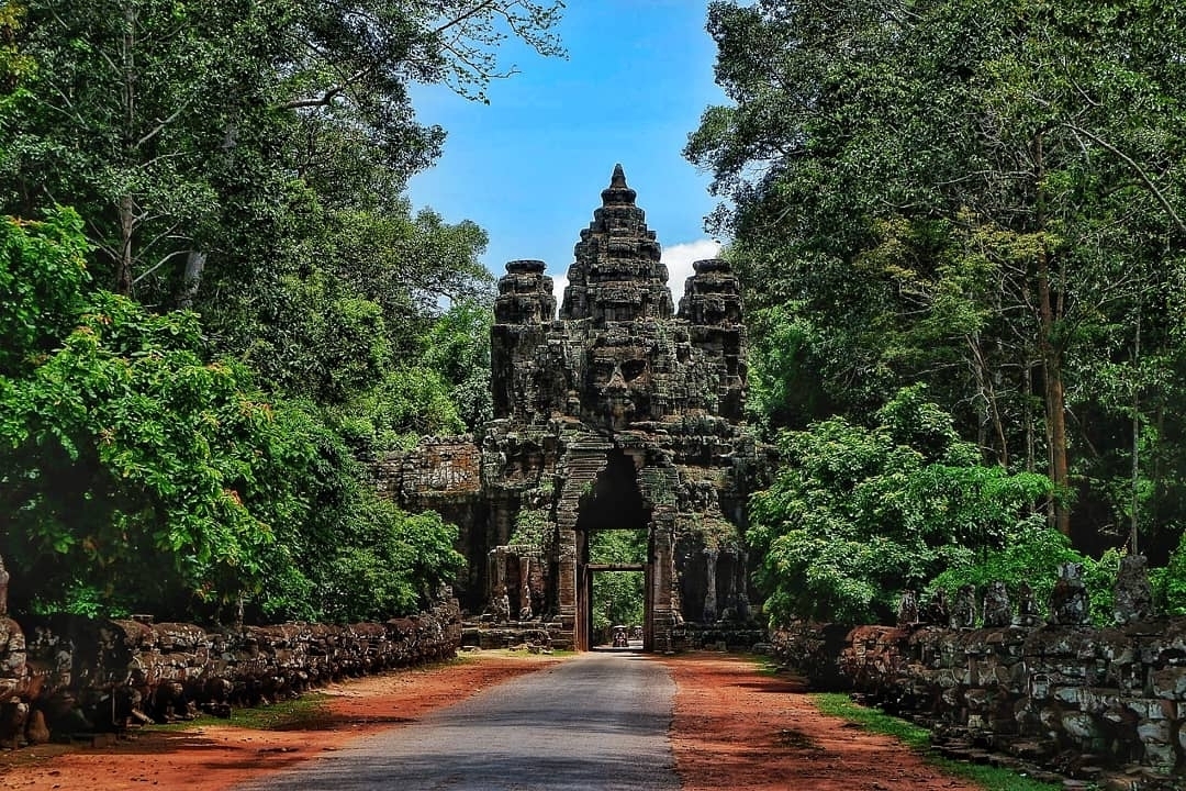 Une ancienne arche de pierre dans une forêt luxuriante.