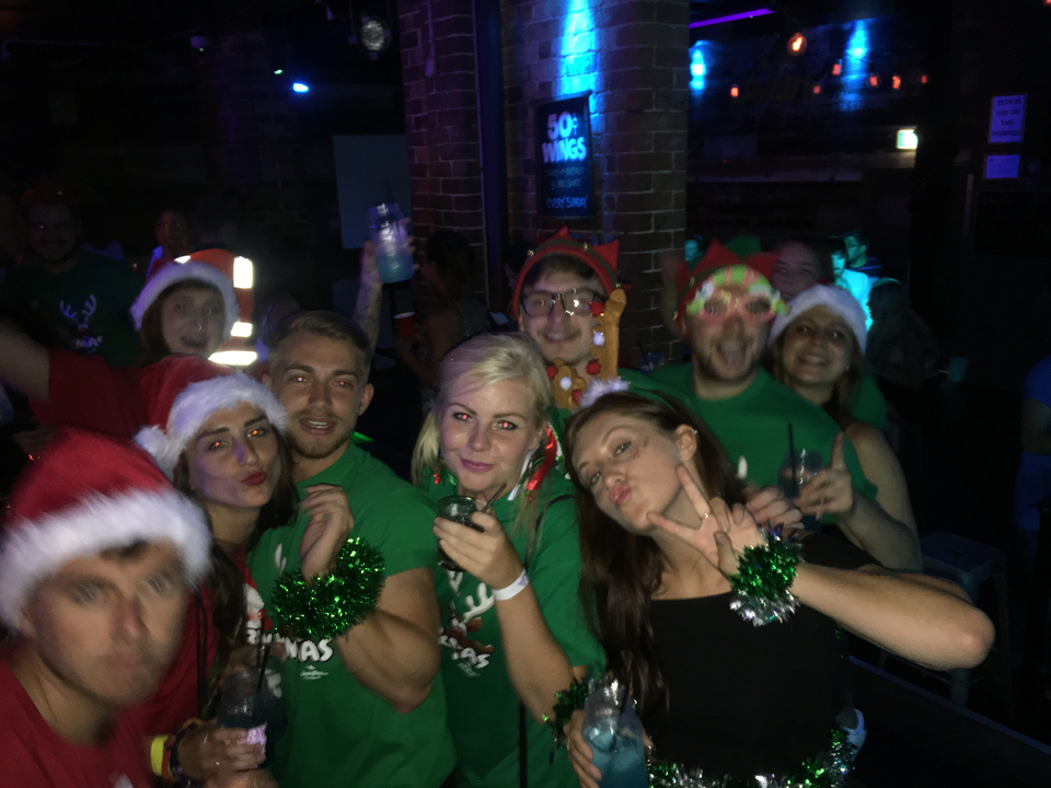 Group of people in festive outfits enjoying a party.