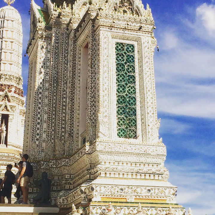 Ornate temple with intricate architectural details against a blue sky.