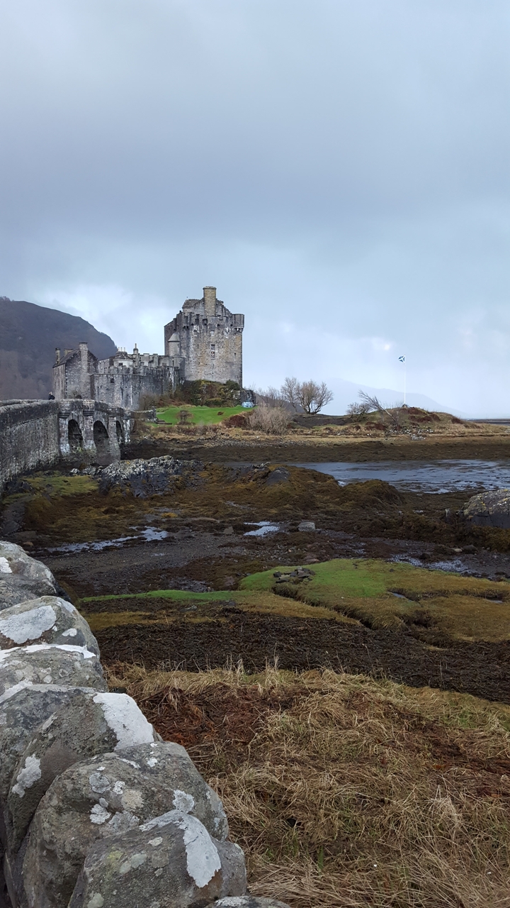 Castle with a stone bridge over tidal waters