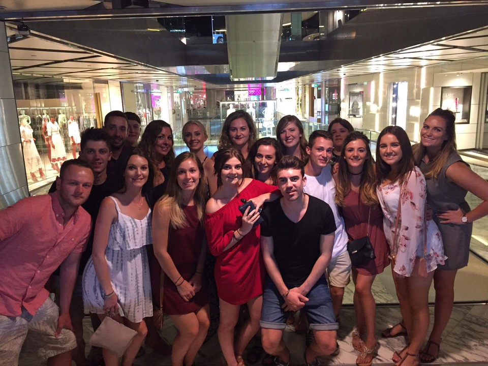 Large group of people posing in a brightly lit indoor area