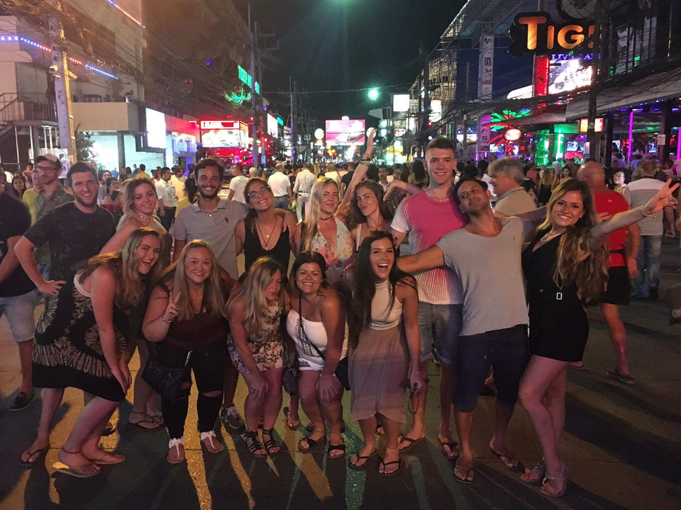 Group of people in a busy nightlife street.