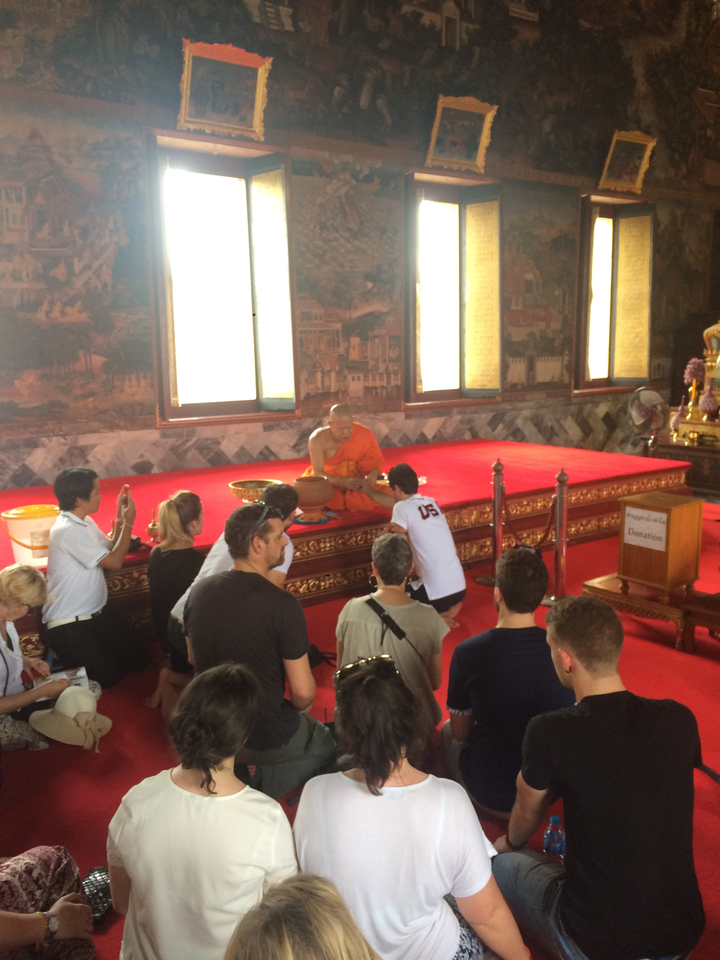 Monk performing a ceremony inside a temple.
