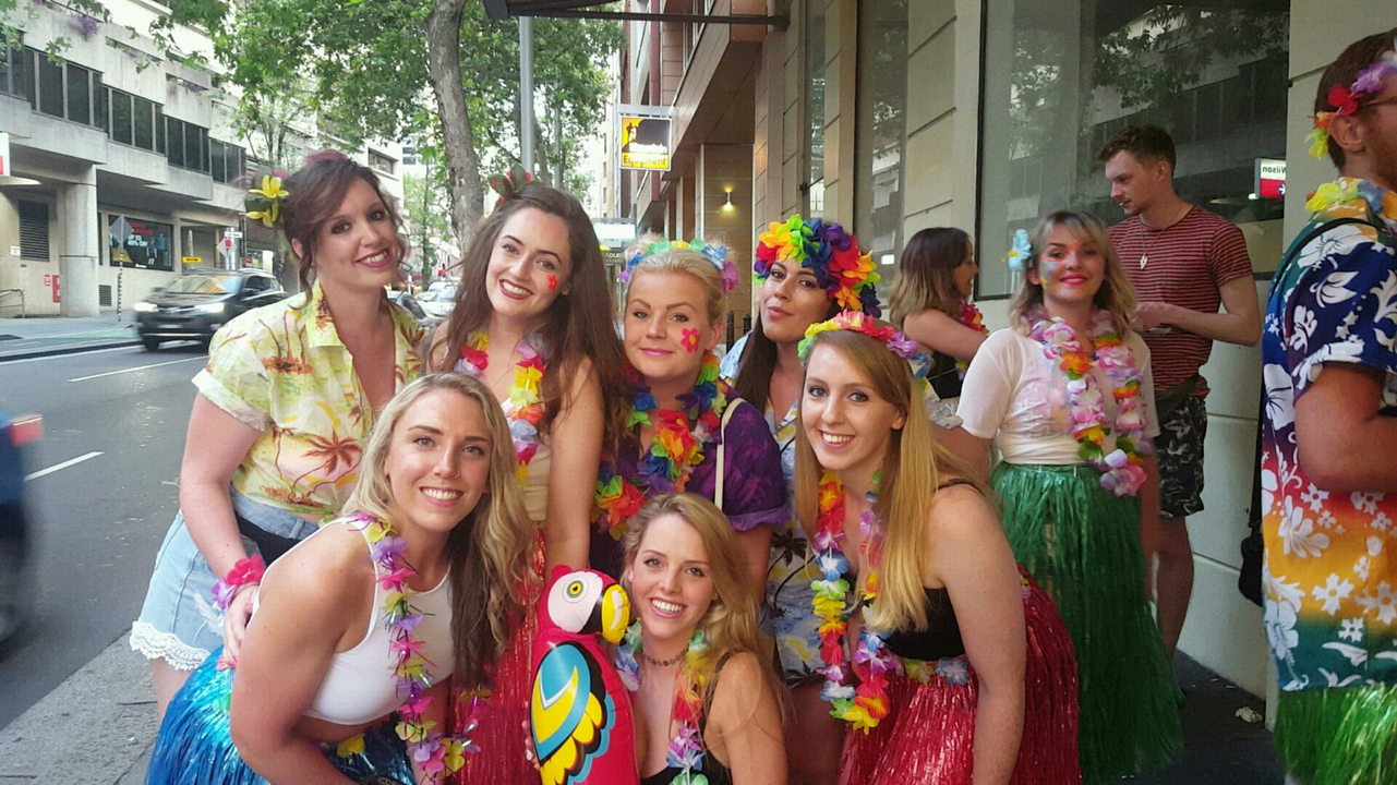 Group of women in colorful outfits in an urban setting.