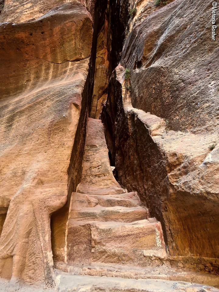 Tight passageway through towering rock formations.