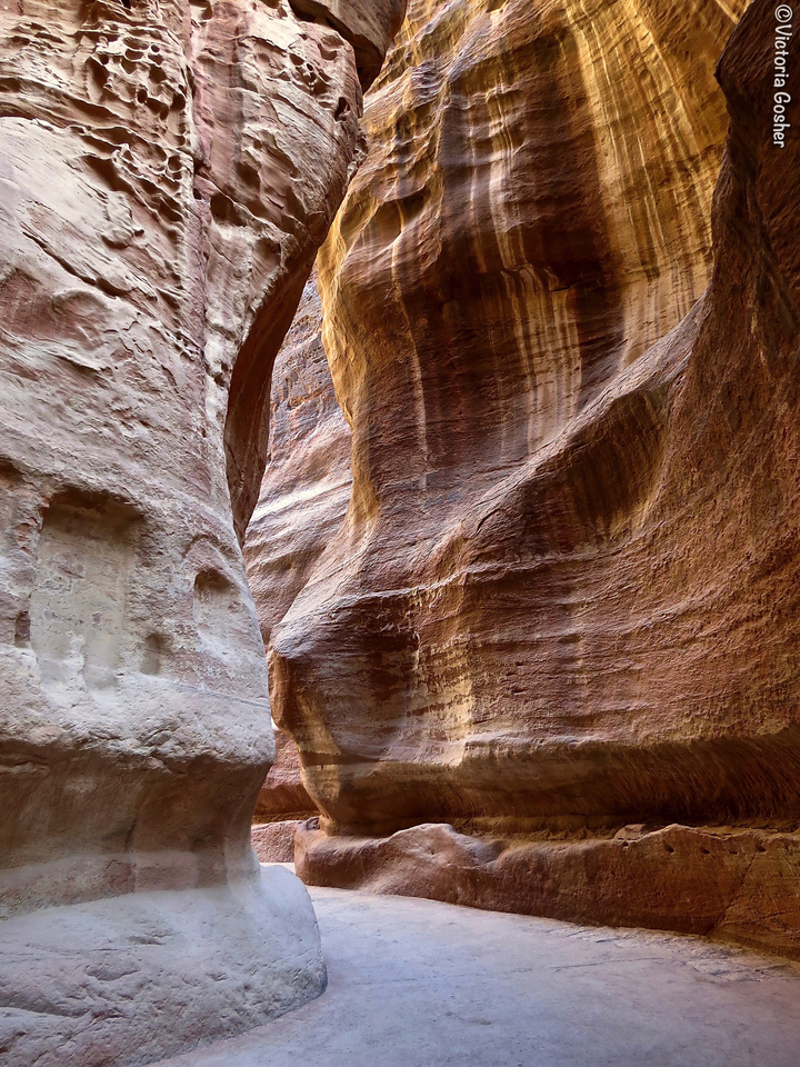 Tall narrow canyon walls with striated patterns.
