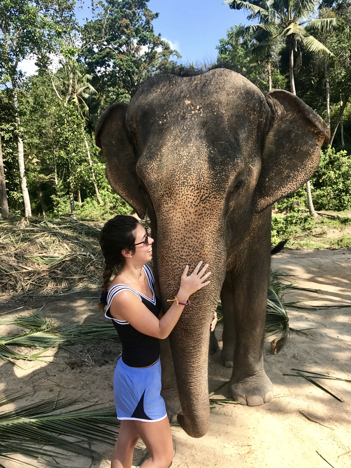 Woman hugging an elephant.