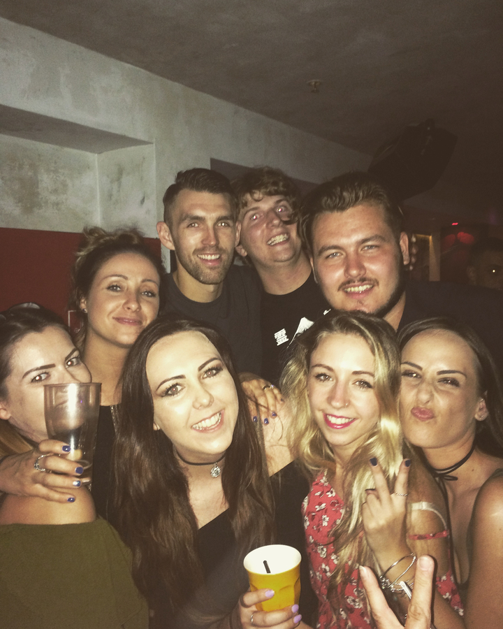 Group of people posing for a photo at a party