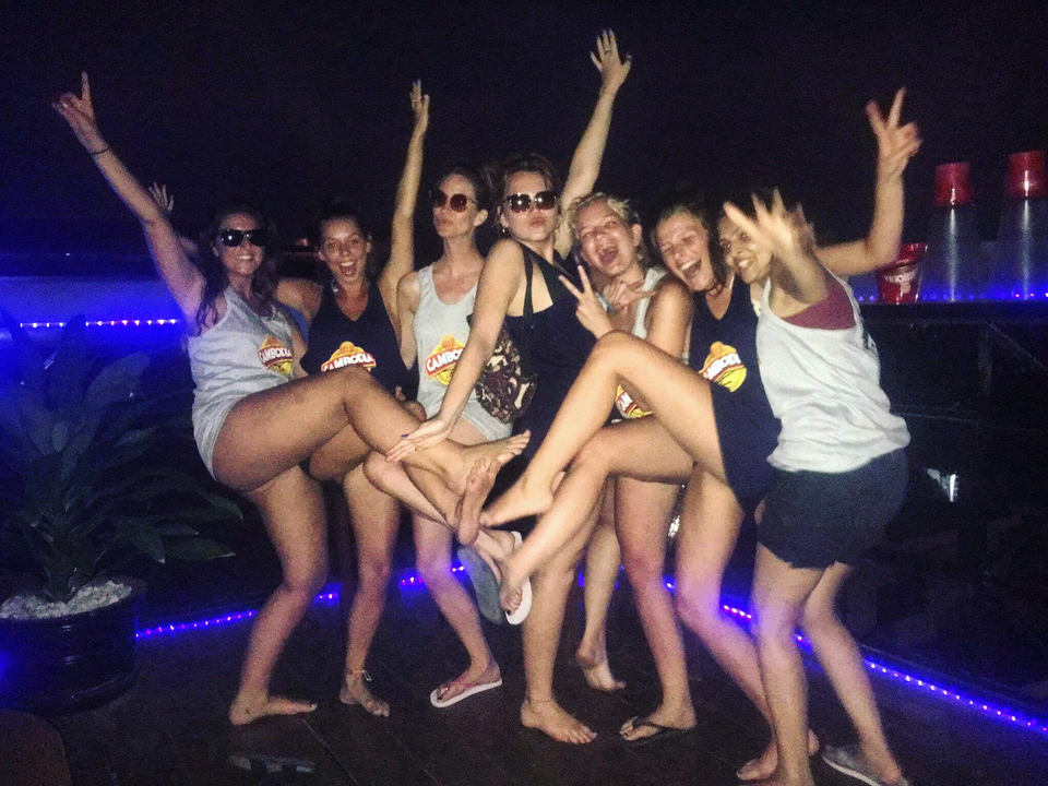 Friends posing in a lively bar setting