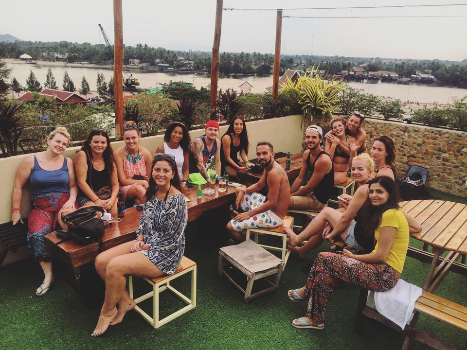 Large group of friends socializing on a rooftop