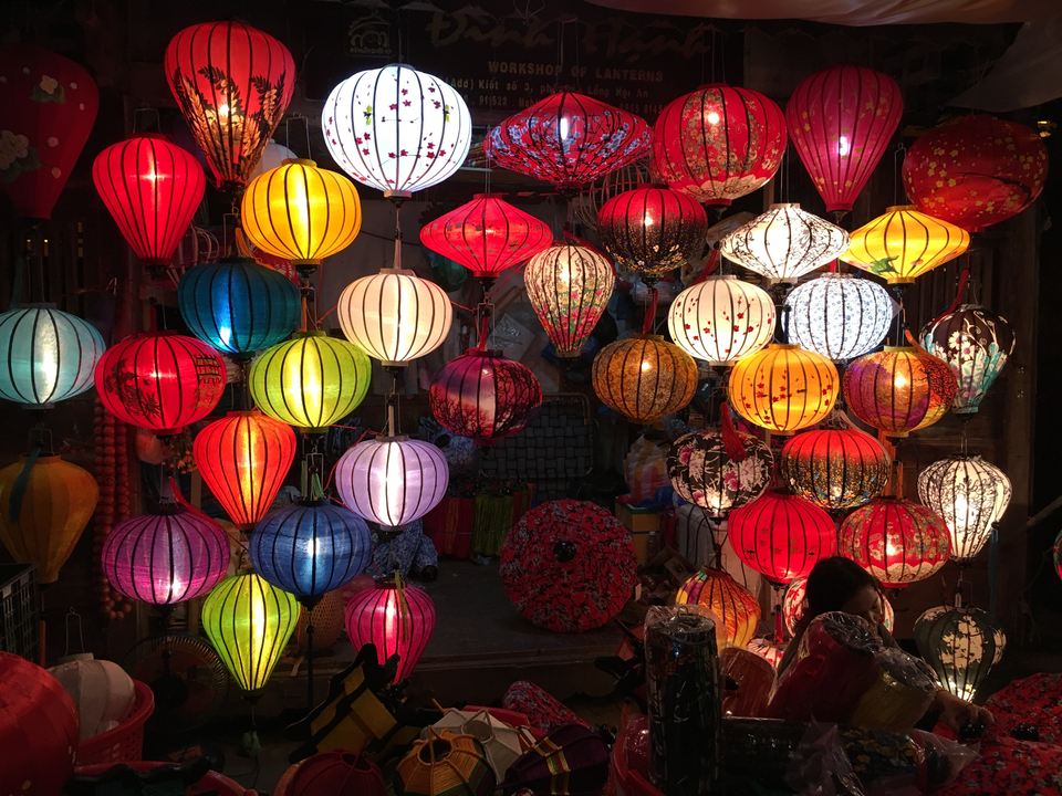 Colorful paper lanterns on display at night.