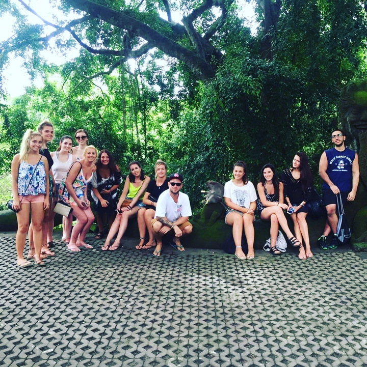 Group photo of people in a forested area.