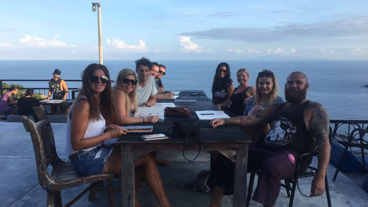 Group of people dining with an ocean view.