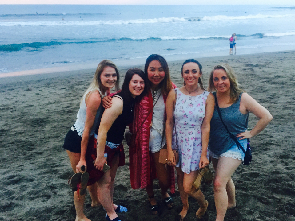 Group of women posing on a beach