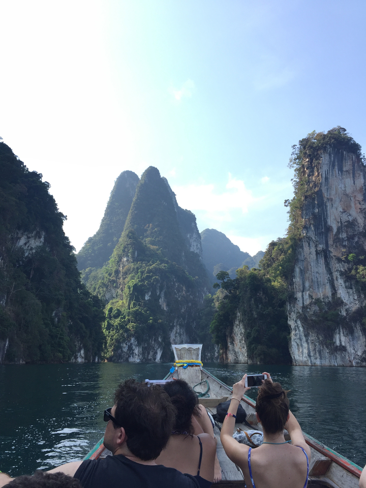 Towering limestone cliffs with dense vegetation.