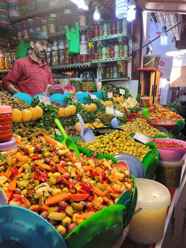 Market stall with colorful preserved foods.