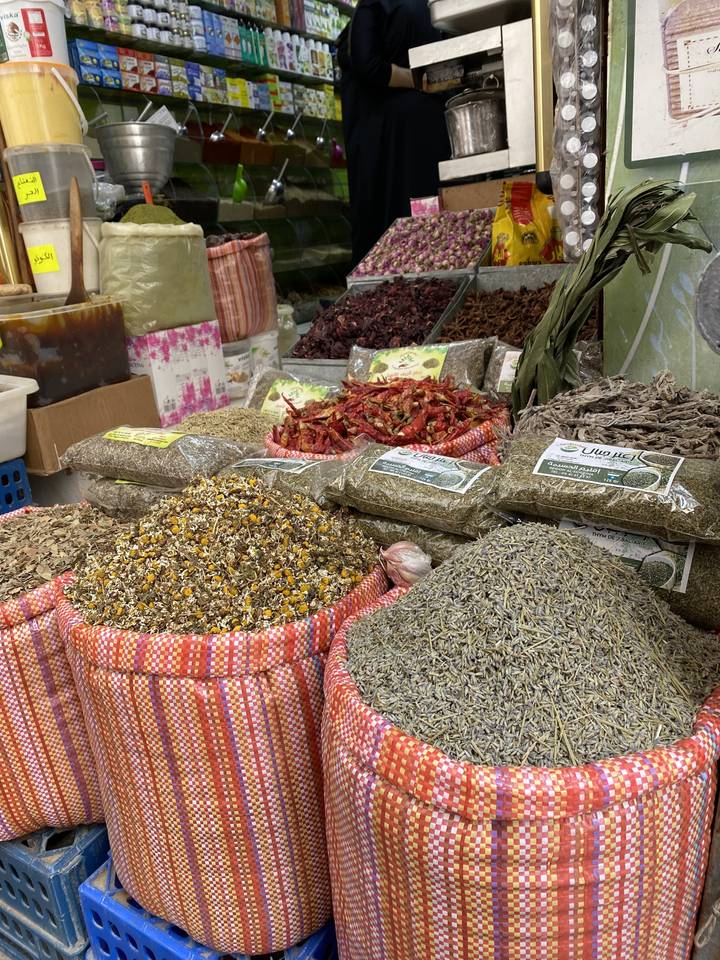 Spice market display with various spices in sacks.