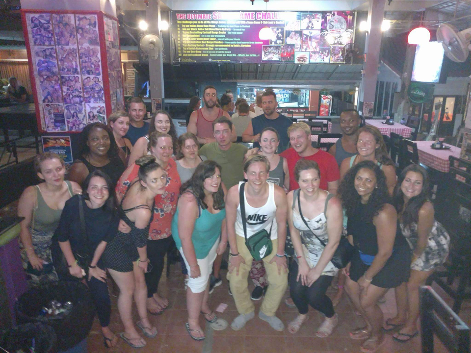 Indoor group photo in a restaurant setting with decorations.