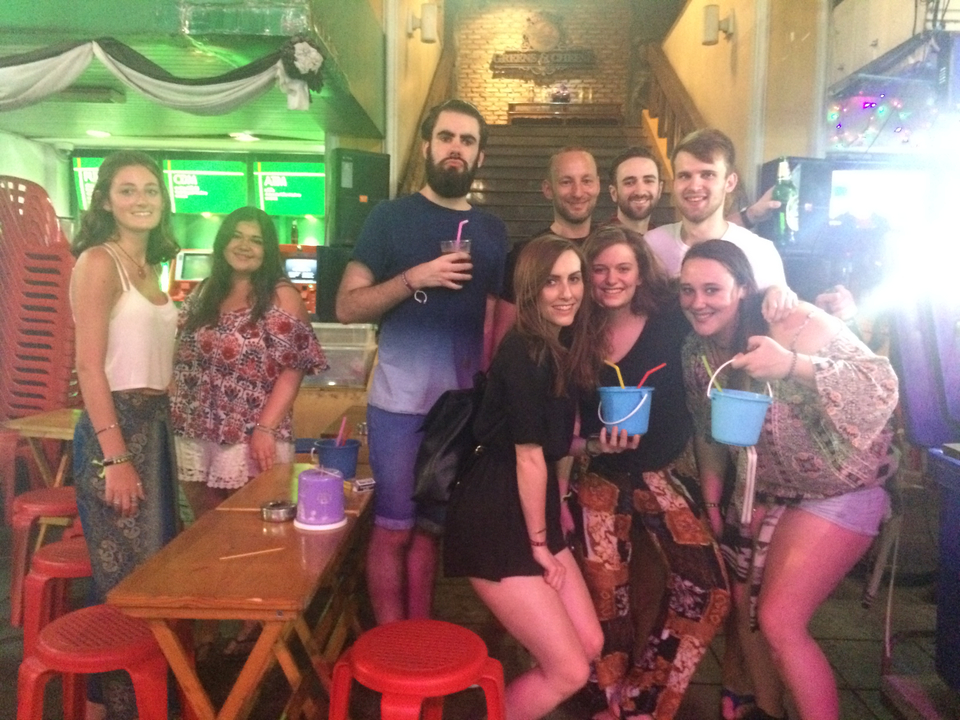 A group of people having drinks at a bar.