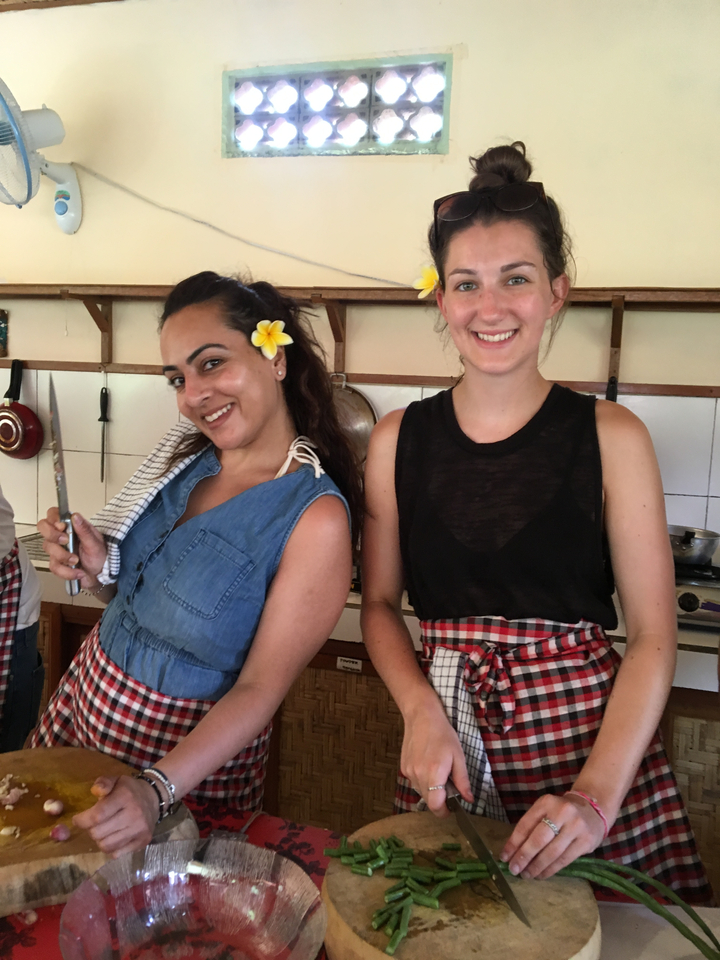 Two women participating in a cooking class.