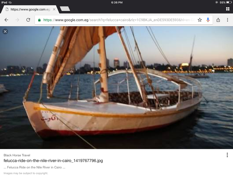 Blurry image of a boat at sunset on a river.