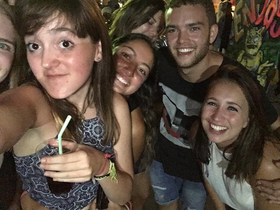 Group of friends taking a selfie, smiling.