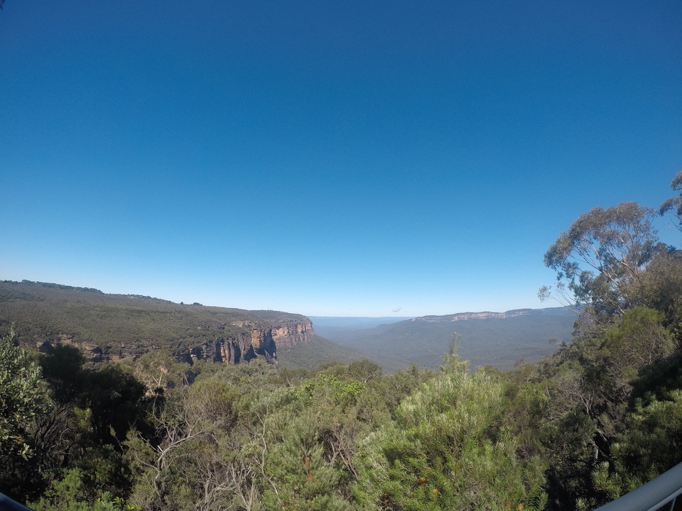 Panoramic view of mountains under clear blue sky.