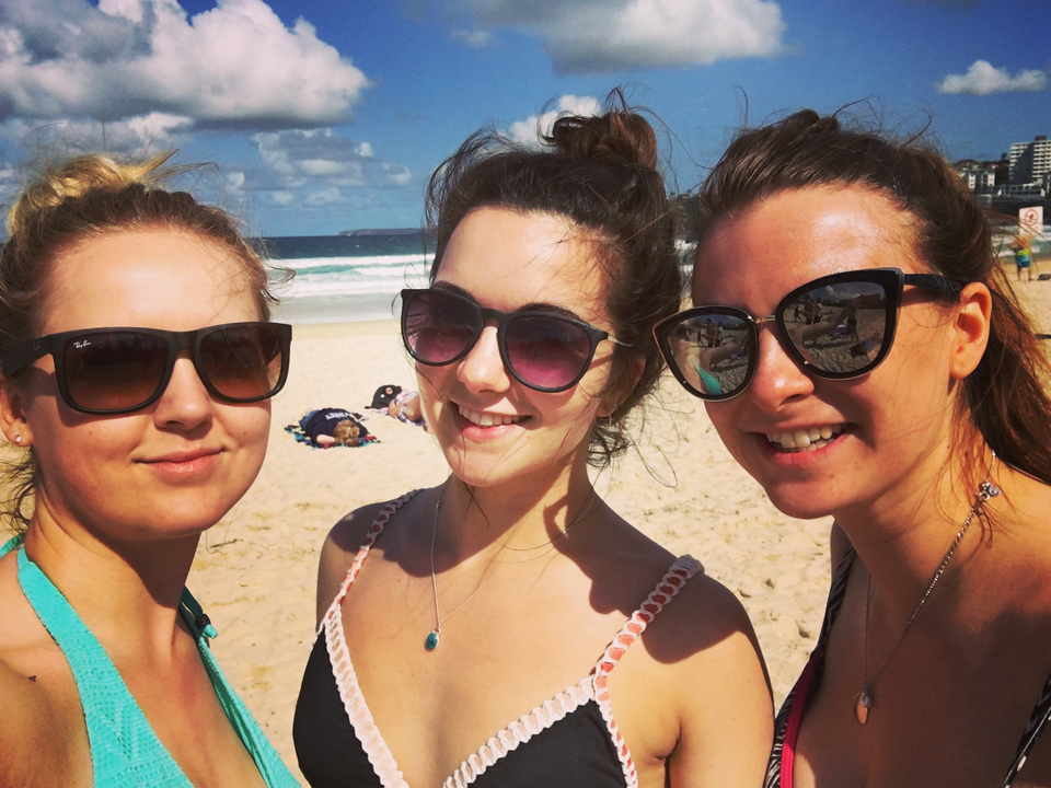 Three women enjoying a sunny day at the beach.