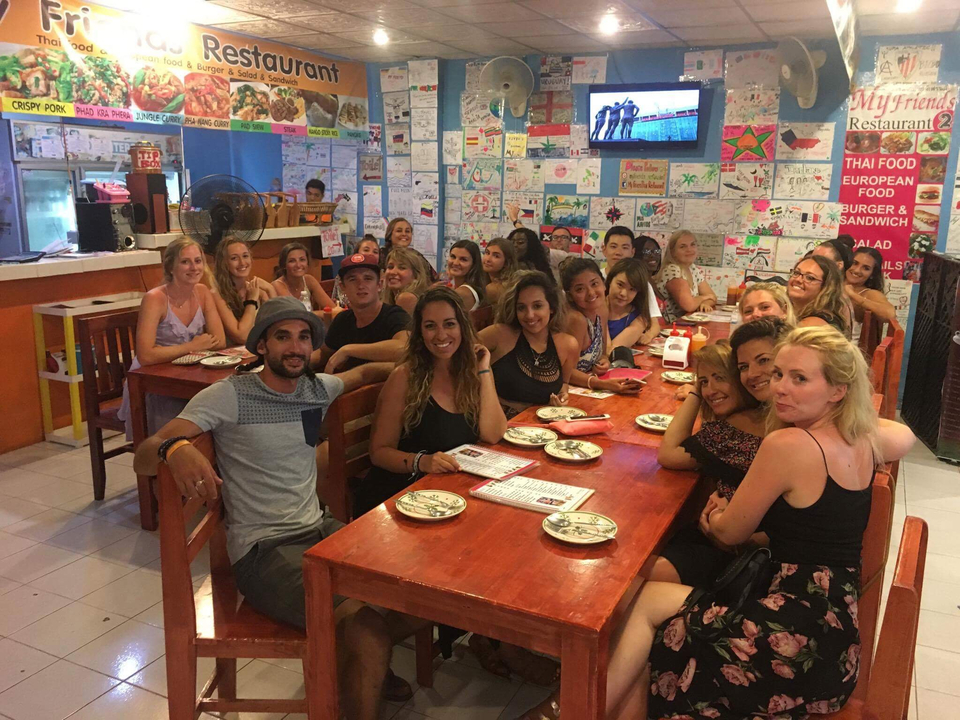 Lively dinner gathering at a restaurant with group of travelers.