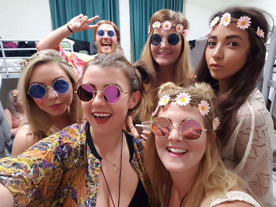 Group of friends wearing sunglasses indoors.