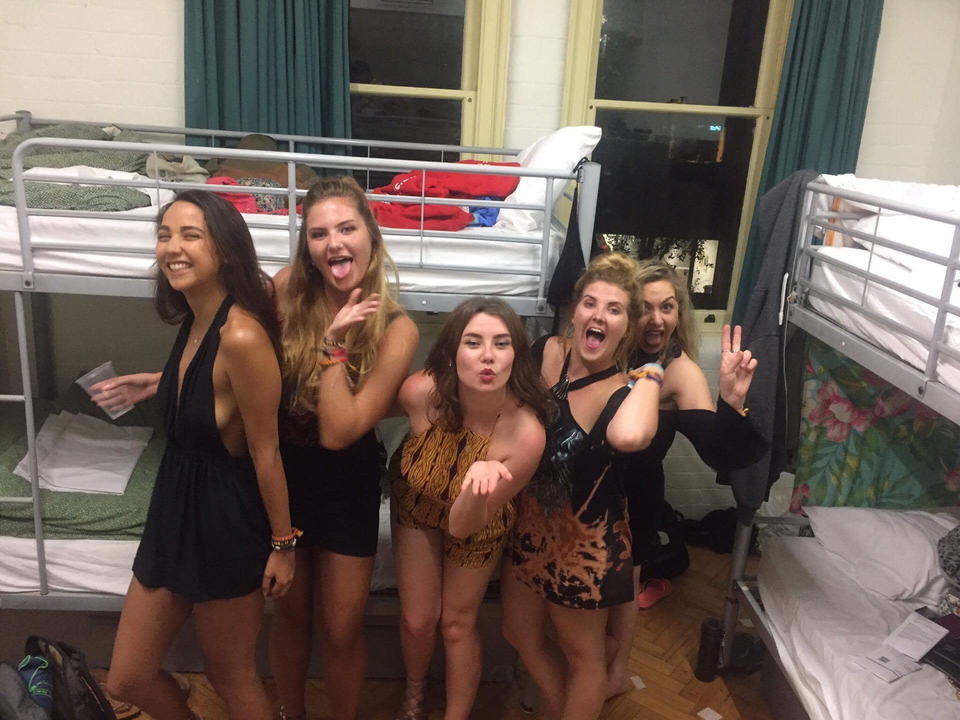 Group of women posing in a dormitory setting.