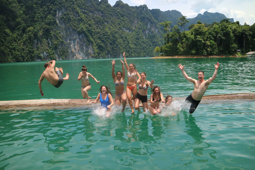Group of people enjoying a splash in a lake.
