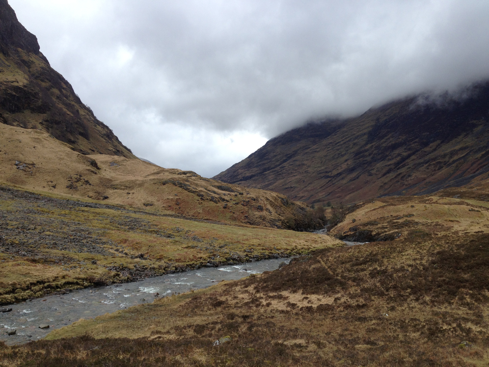 Breathtaking view of a misty valley between rolling hills.