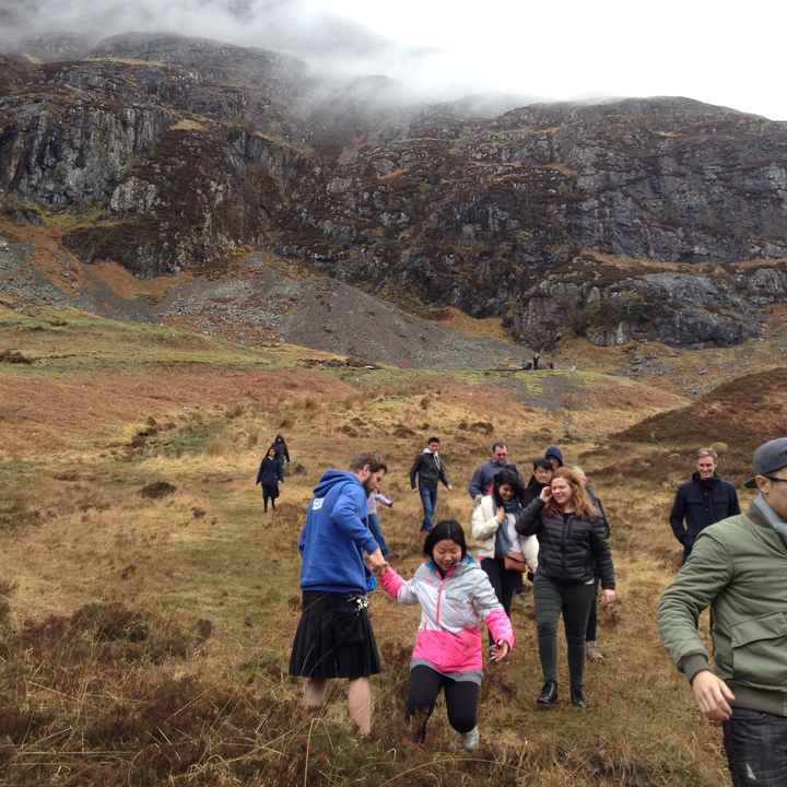 People walking in a rocky hillside area.