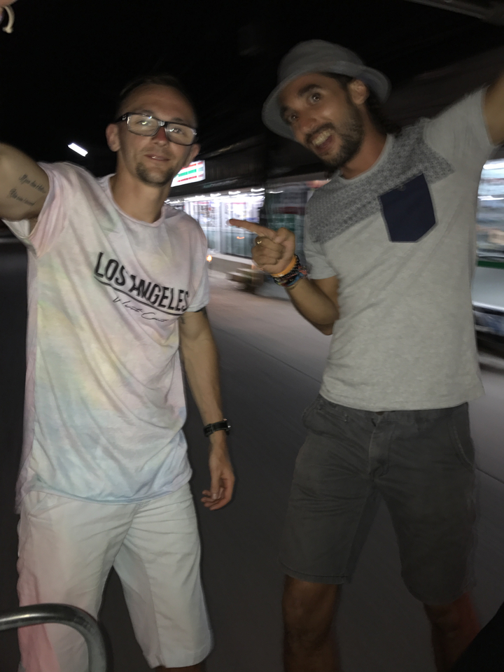 Two people captured mid-motion on a nighttime street.