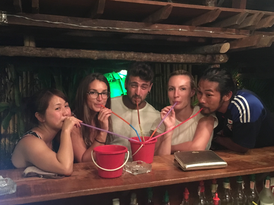 Group of people sharing drinks with straws.
