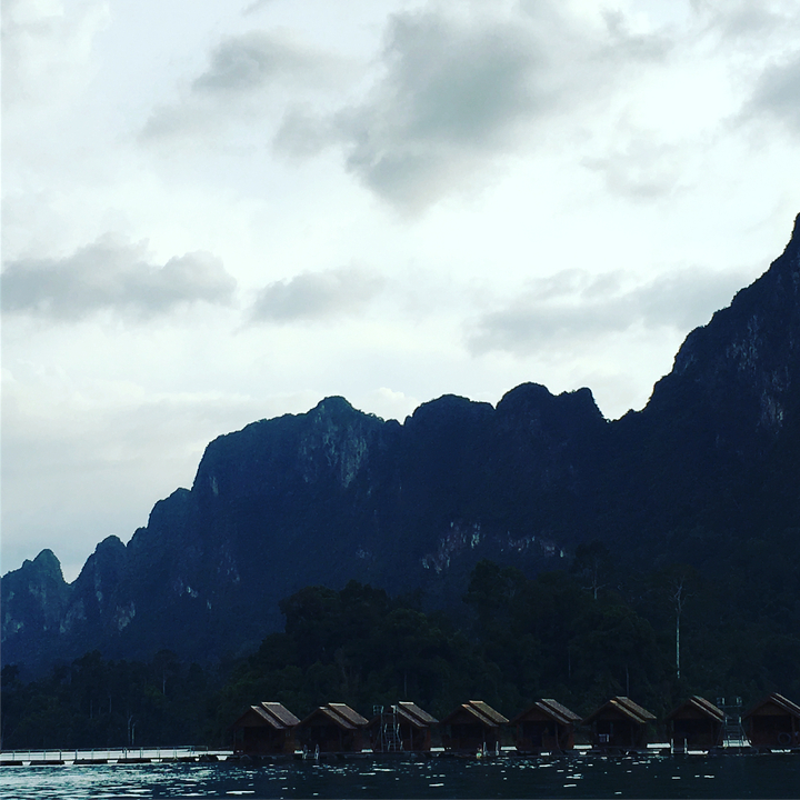Silhouette of mountains under a cloudy sky.