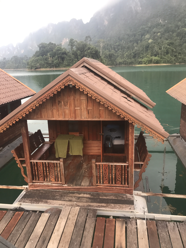 A traditional wooden cabin floating on water.