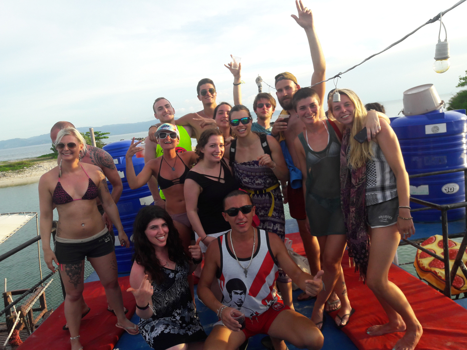 Group of friends posing on a boat, having fun.