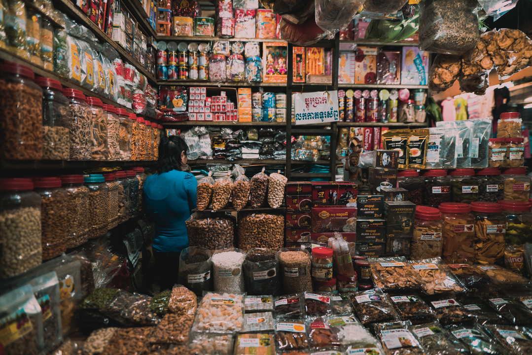 Local market stall filled with various goods and products.