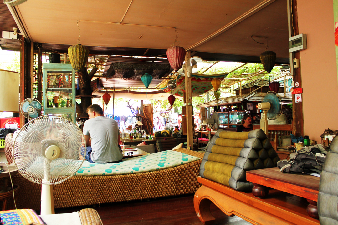 People sitting in a colorful and decorative indoor market.