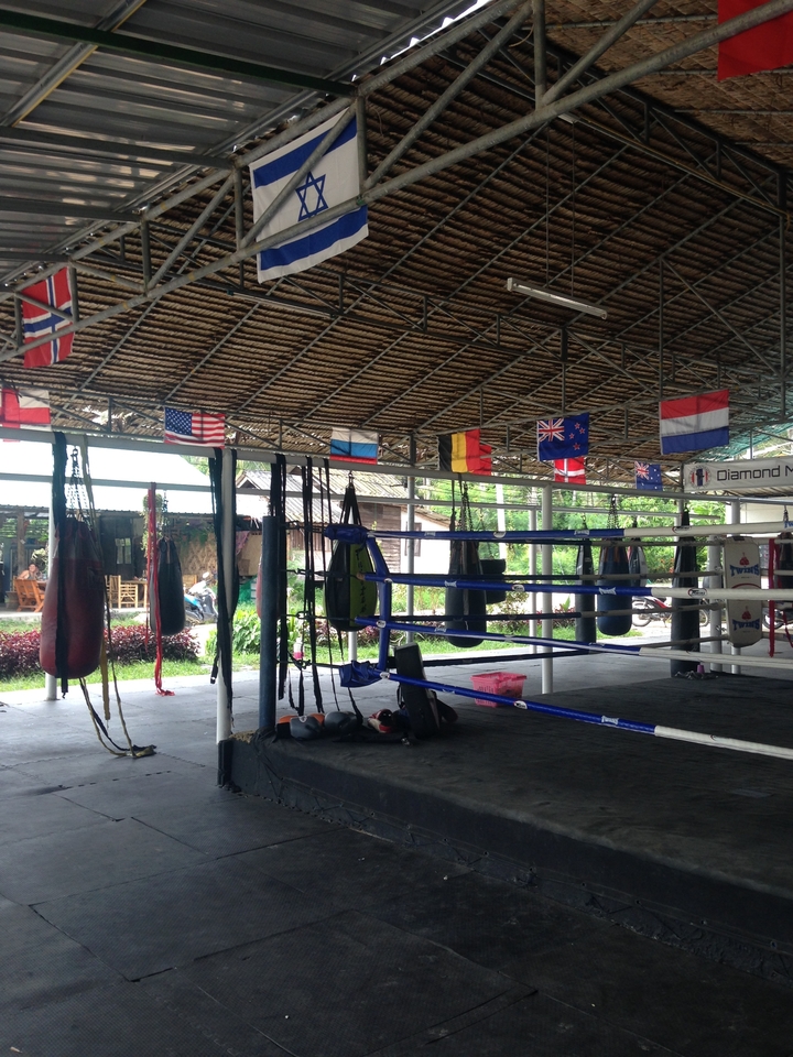 Muay Thai boxing ring with flags.