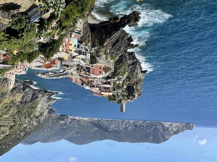 Villages along a rugged coastline with blue waters.
