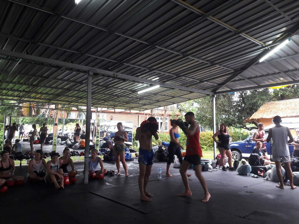 People performing a boxing training session.