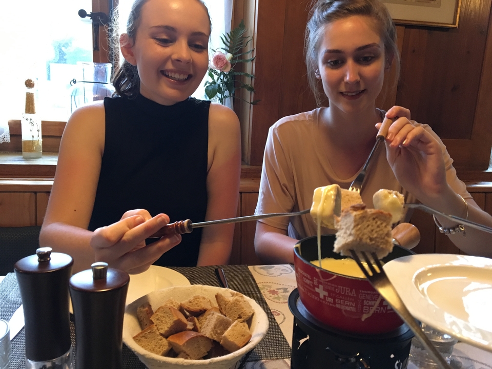 Two people enjoying a fondue experience.