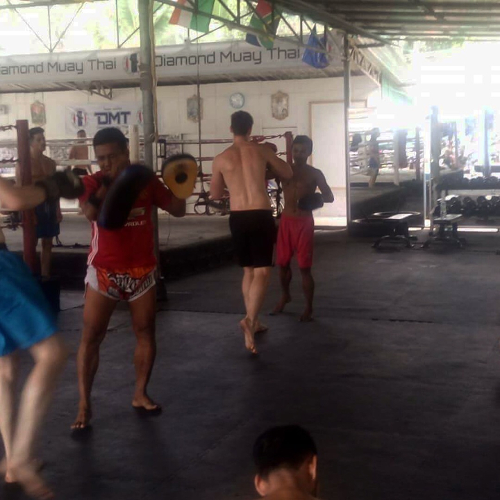 Indoor scene of people participating in a martial arts class.
