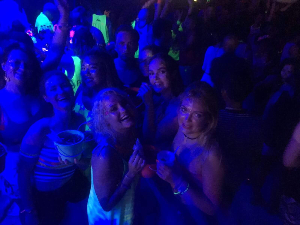 Group of friends enjoying a night party with drinks.