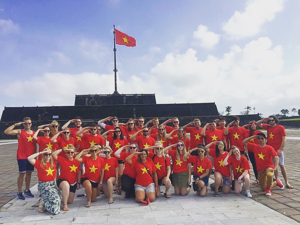 Group of people wearing Vietnam flag shirts posing for a photo.