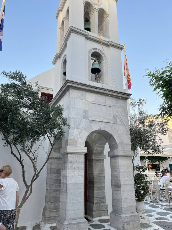 Stone bell tower with arches and bells.
