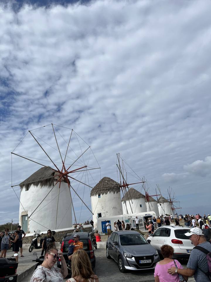 Famous windmills with a crowd gathered around them.